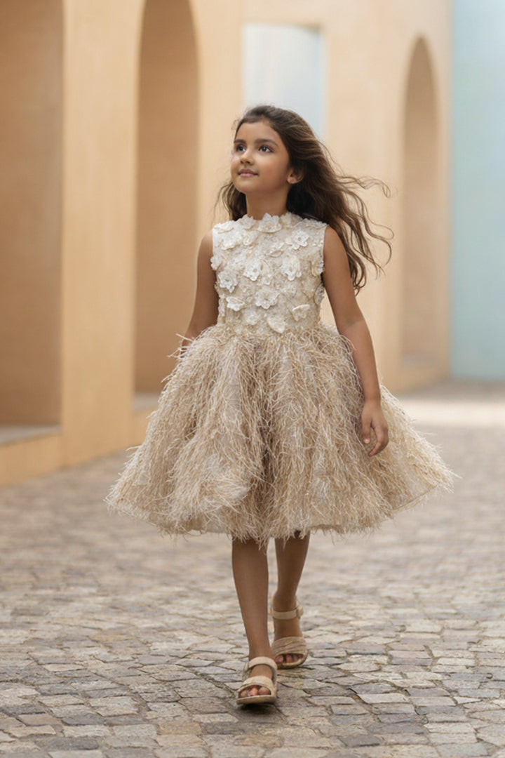 A young girl walking while wearing a golden-colored fur dress from Nibblekins.