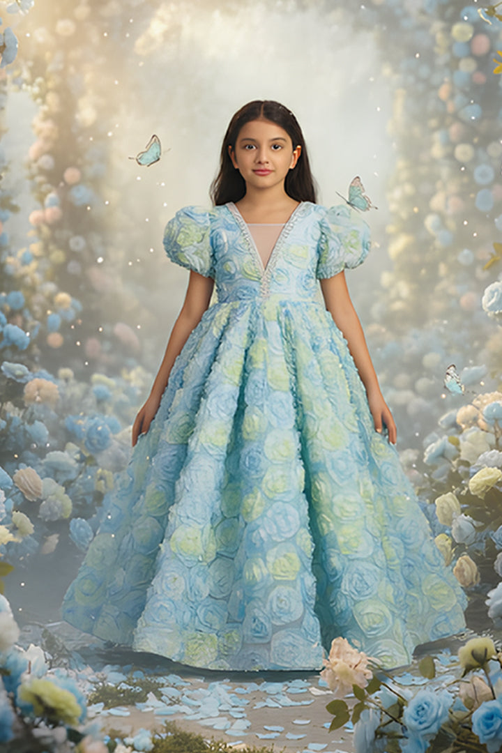 A young girl in a light blue floral dress from Nibblekins, surrounded by butterflies and flowers 