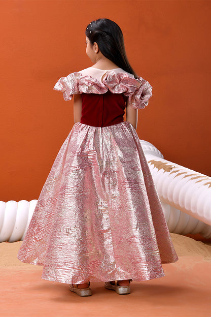 Young girl wearing a pink and red dress against an orange background