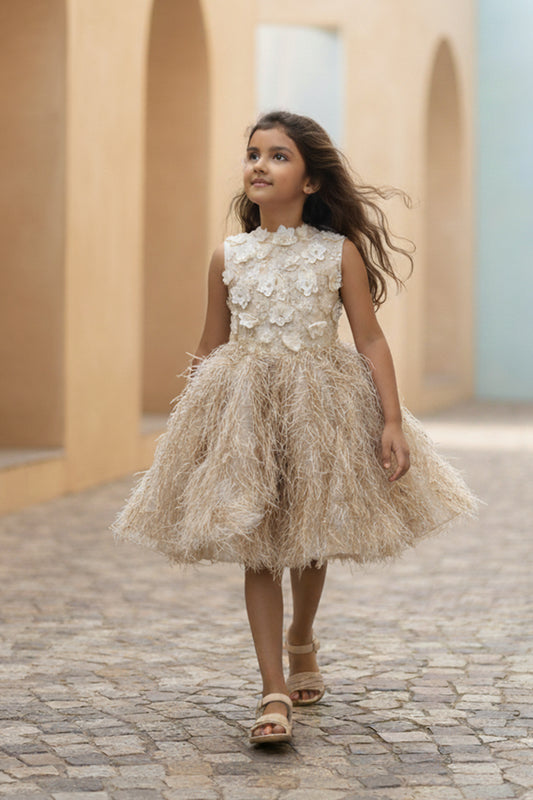 A Young girl in a golden fur dress from Nibblekins walking on a cobblestone path with arches in the background