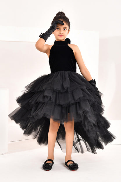 Young girl wearing a black high low dress from nibblekins with white background