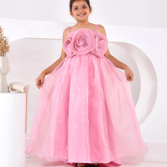 a young girl wearing a pink train gown 