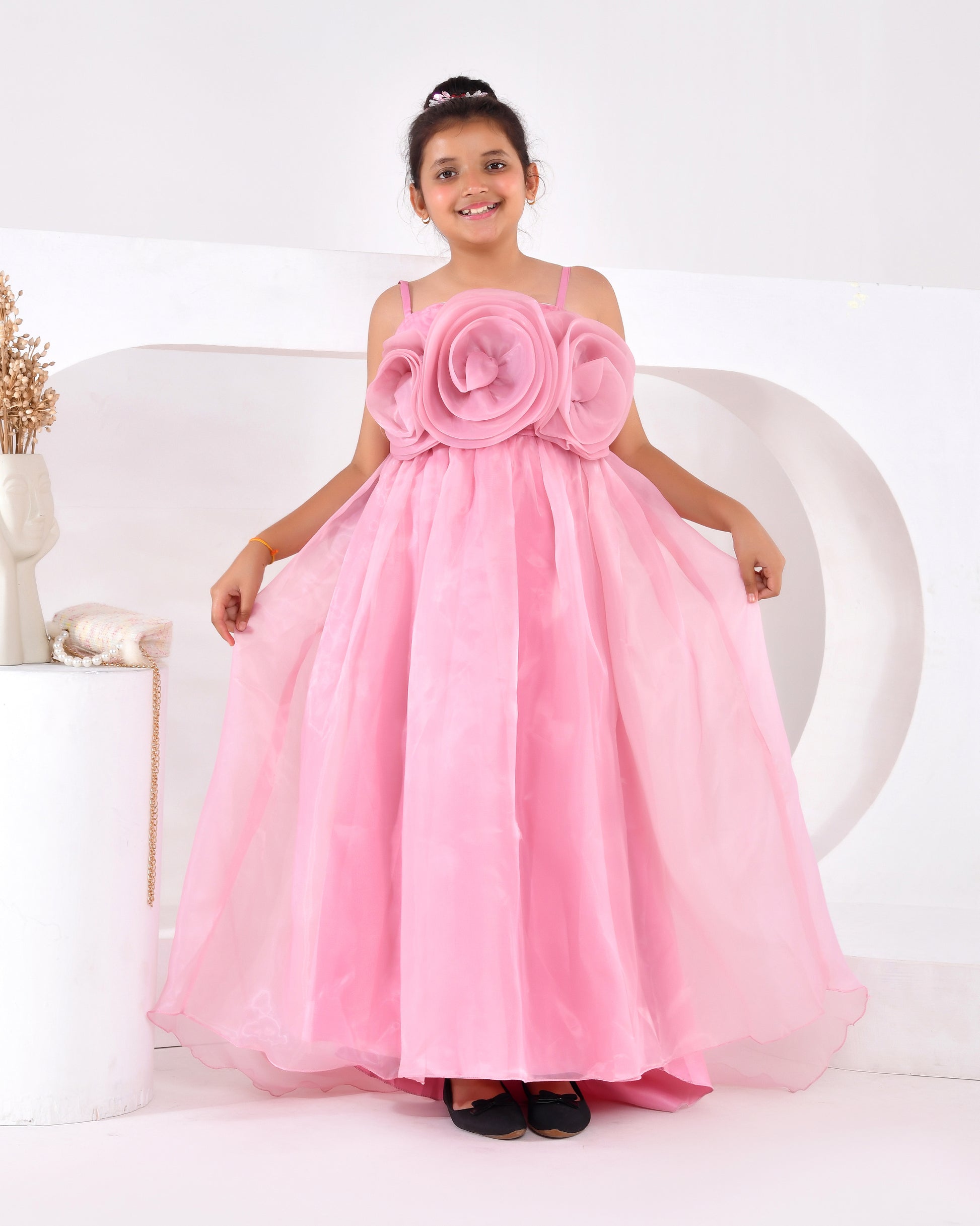 a young girl wearing a pink train gown 