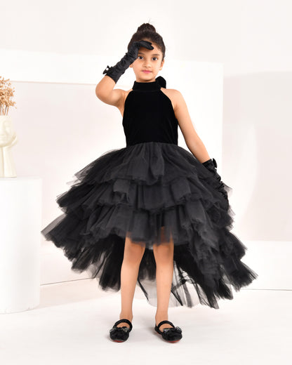 a young girl wearing black high low dress from nibblekins with white background 