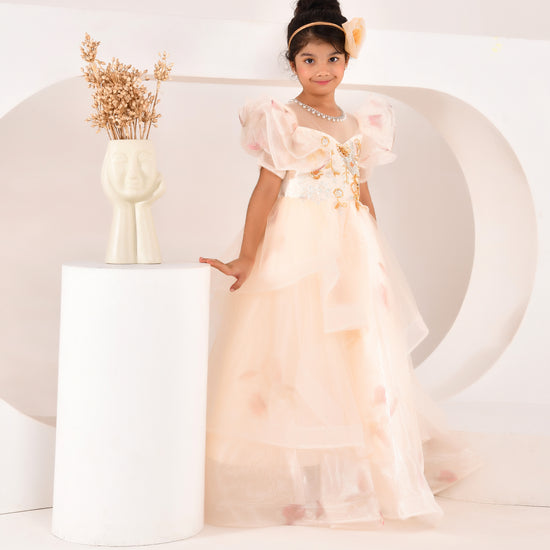 a young wearing a ivory princess gown from nibblekins with white background