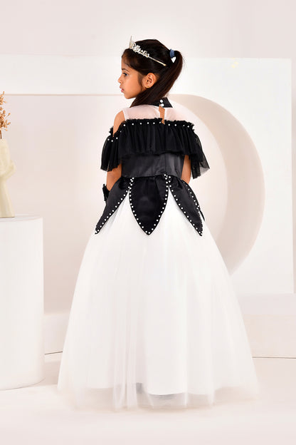 Young girl in a black and white dress with studded details on a white background