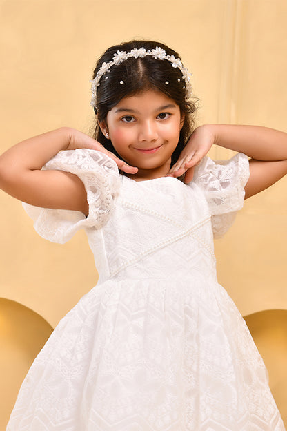 a young girl wearing white lace dress with boho theme background